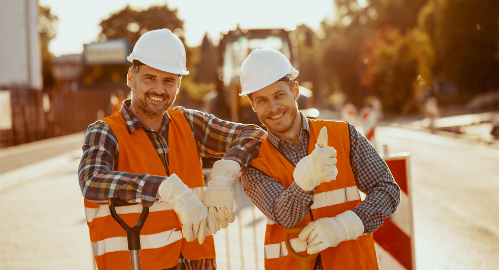 Two construction workers taking a photo