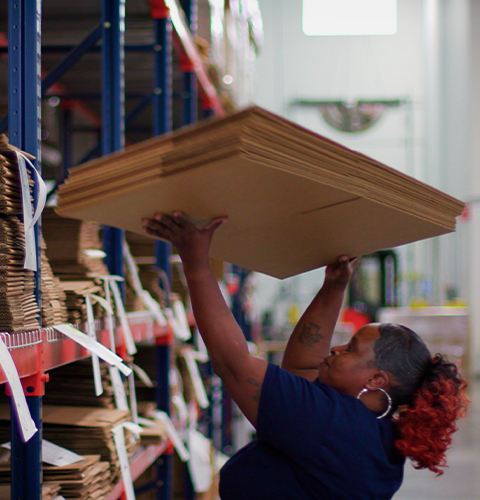 Woman lifting cardboard boxes