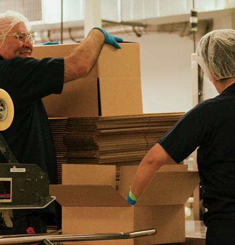Employees smiling while setting up boxes