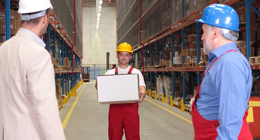 Warehouse employee lifting box at work