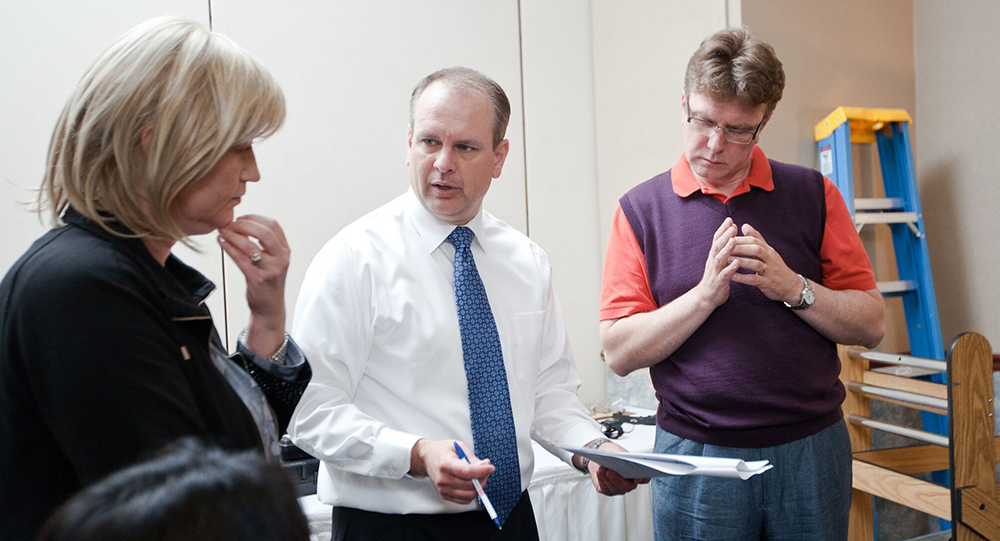 Jim Mecham explaining good form to two attendees
