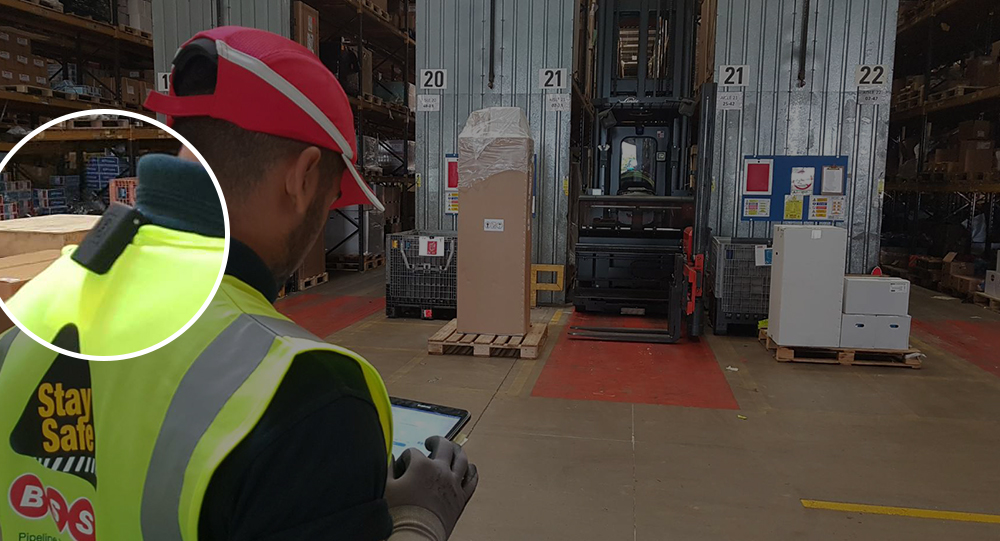 Zoomed in device on employees vest